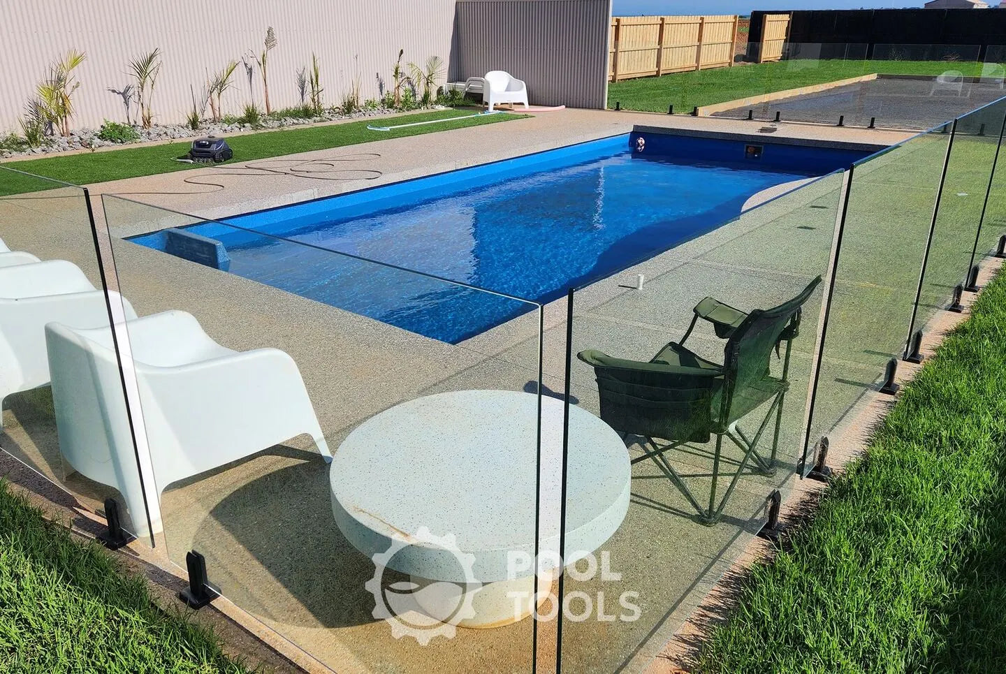 Swimming pool with patio furniture and 'Pool Tools' logo.