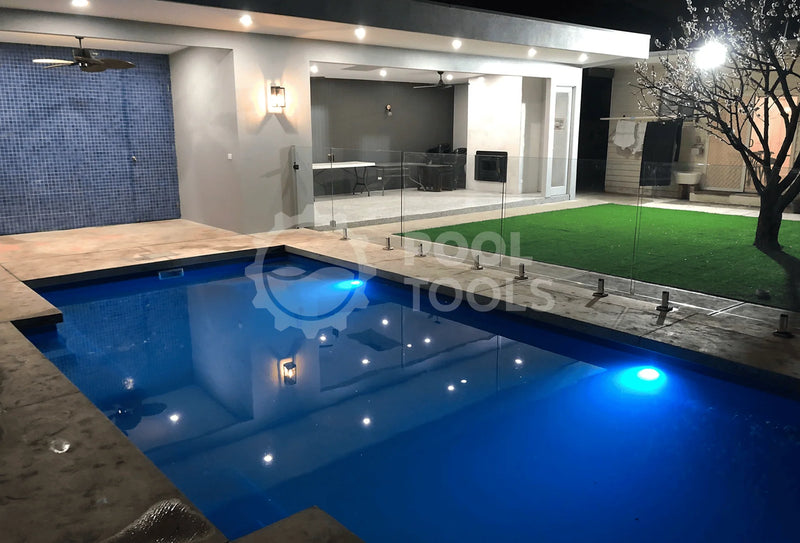 Pool Tools project - Modern outdoor pool area with blue water, stone deck, and garden.