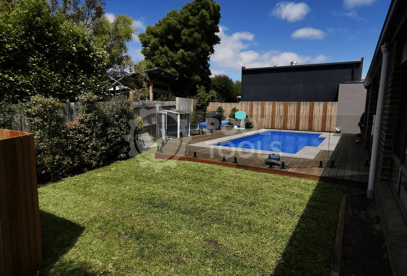 Pool Tools project - Backyard with pool, grass, and trees on a sunny day